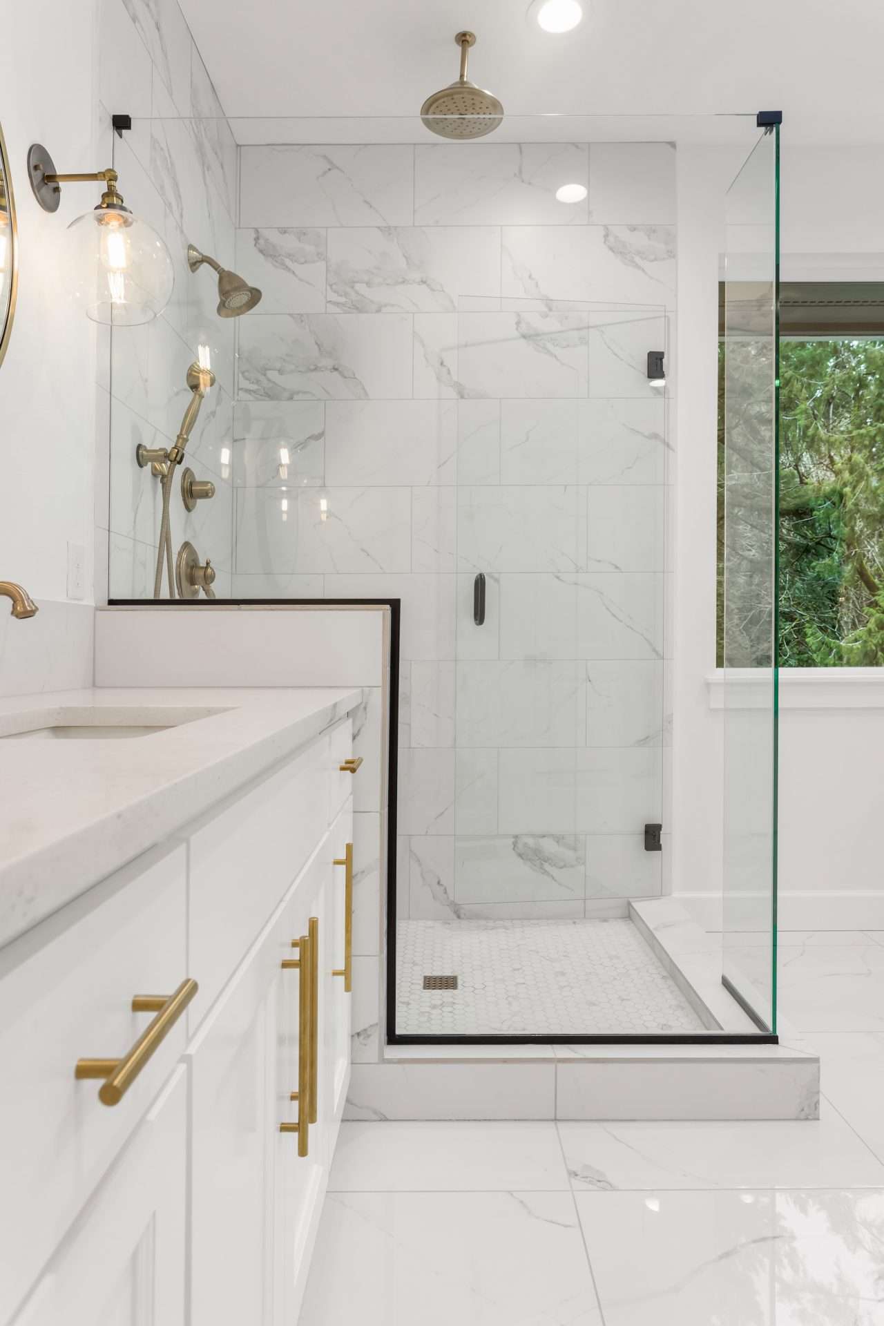 Modern marble-tiled shower with brass fixtures
